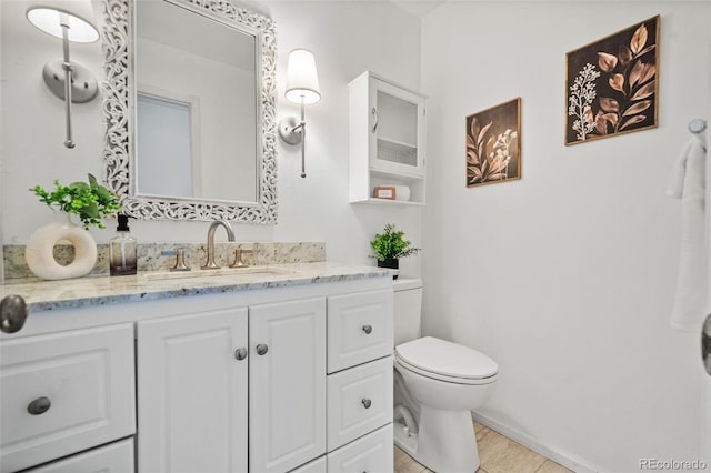 bathroom featuring toilet, hardwood / wood-style floors, and vanity