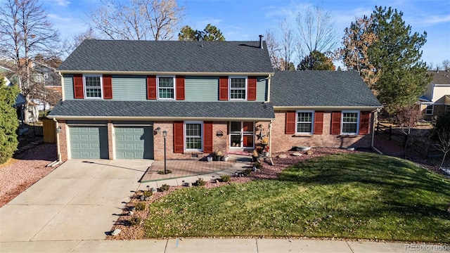 view of property featuring a front lawn and a garage