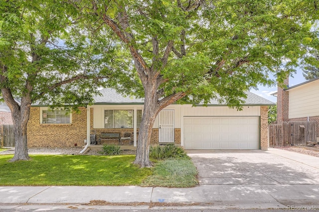 6314 S Johnson St, Littleton, CO 80123 - view of front of property with driveway, brick siding, and a garage