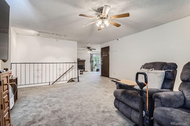6314 S Johnson St, Littleton, CO 80123 - living area featuring ceiling fan, a textured ceiling, an upstairs landing, carpet floors, and rail lighting