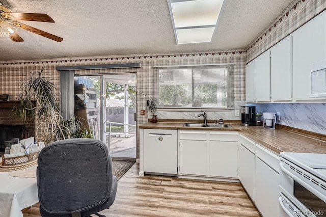 6314 S Johnson St, Littleton, CO 80123 - kitchen featuring a textured ceiling, white appliances, light wood-style flooring, a ceiling fan, and plenty of natural light