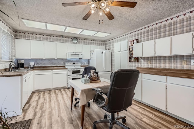 6314 S Johnson St, Littleton, CO 80123 - kitchen with white appliances, a textured ceiling, light wood-style flooring, white cabinetry, and a ceiling fan