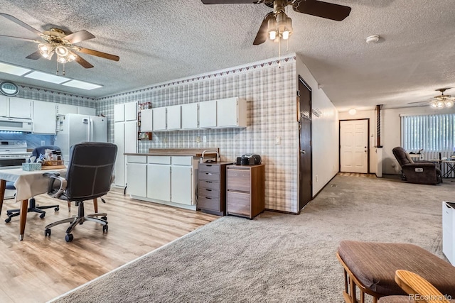 6314 S Johnson St, Littleton, CO 80123 - office area featuring ceiling fan, a textured ceiling, wallpapered walls, and light carpet