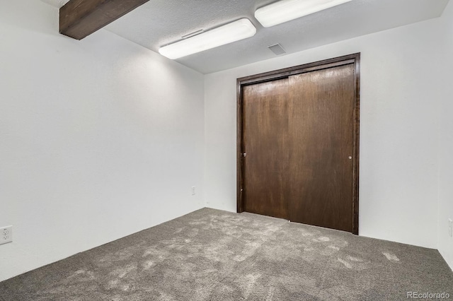 6314 S Johnson St, Littleton, CO 80123 - unfurnished bedroom with carpet, a closet, and beamed ceiling
