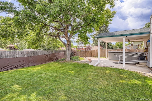 6314 S Johnson St, Littleton, CO 80123 - fenced backyard with a hot tub, a patio, and a ceiling fan