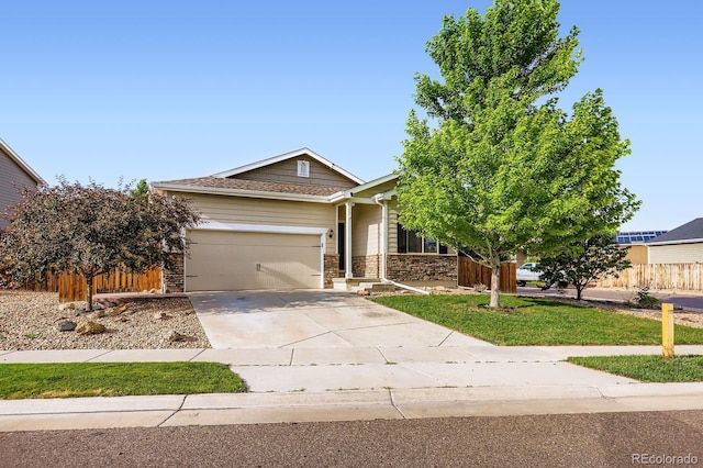 449 Vista Blvd, Lochbuie, CO 80603 - view of front of home featuring driveway, an attached garage, and stone siding