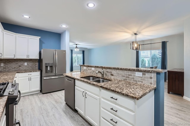 449 Vista Blvd, Lochbuie, CO 80603 - kitchen with appliances with stainless steel finishes, decorative backsplash, plenty of natural light, and recessed lighting