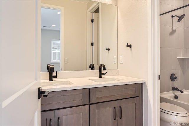 full bathroom featuring vanity, toilet, and tiled shower / bath combo