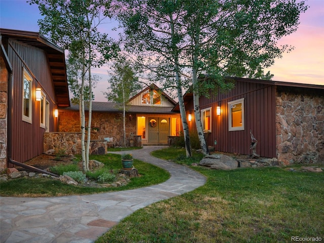 28550 Cavan Ln, Evergreen, CO 80439 - view of front of home featuring stone siding, board and batten siding, and a front yard