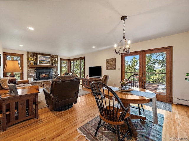 28550 Cavan Ln, Evergreen, CO 80439 - dining area featuring healthy amount of natural light, a chandelier, light wood-type flooring, a fireplace, and recessed lighting