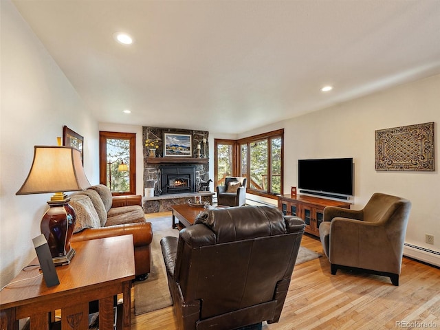 28550 Cavan Ln, Evergreen, CO 80439 - living room featuring plenty of natural light, light wood-style floors, a fireplace, and recessed lighting