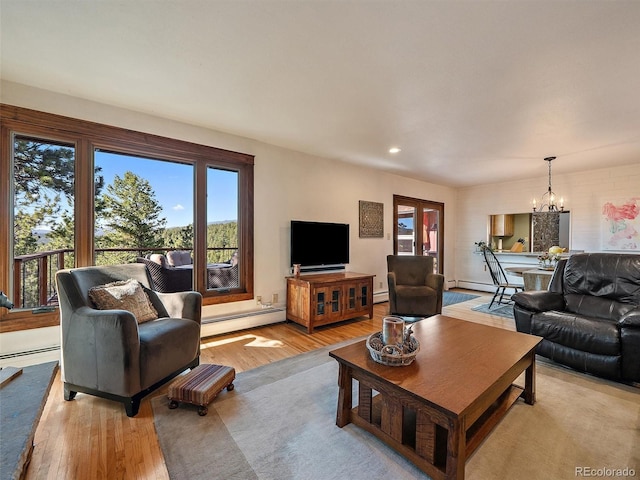 28550 Cavan Ln, Evergreen, CO 80439 - living room with a baseboard heating unit, light wood finished floors, a chandelier, and recessed lighting
