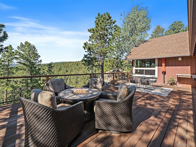 28550 Cavan Ln, Evergreen, CO 80439 - wooden deck featuring outdoor dining area and a fire pit