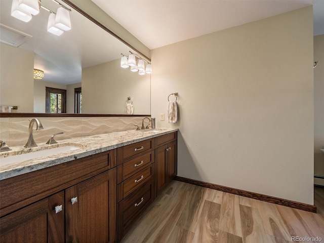 28550 Cavan Ln, Evergreen, CO 80439 - bathroom with double vanity, wood finished floors, and a baseboard heating unit