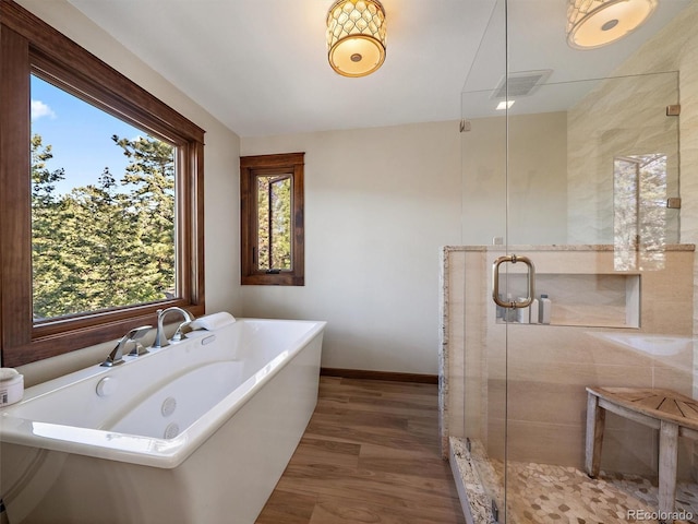 28550 Cavan Ln, Evergreen, CO 80439 - full bathroom featuring a freestanding bath, wood finished floors, and a stall shower