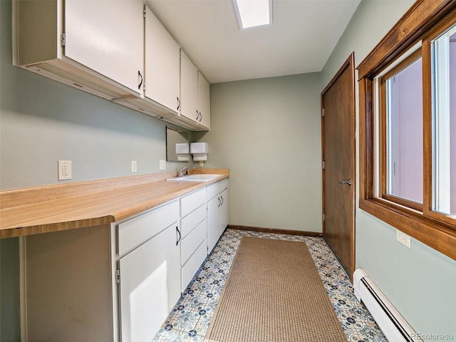 28550 Cavan Ln, Evergreen, CO 80439 - laundry room with baseboard heating and a sink