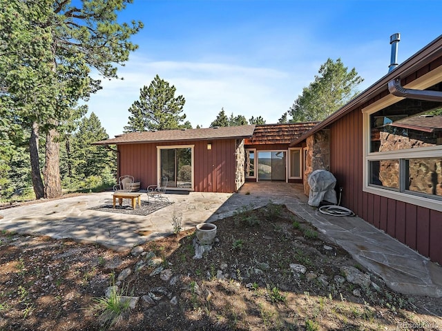 28550 Cavan Ln, Evergreen, CO 80439 - rear view of property featuring a patio area and stone siding