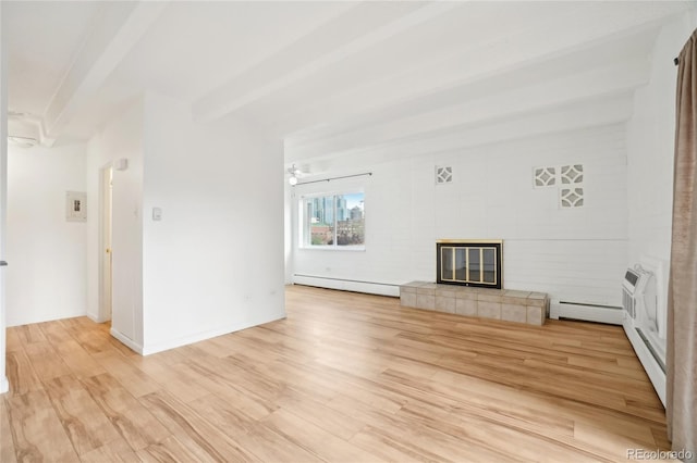 unfurnished living room with a baseboard heating unit, light wood-type flooring, a tiled fireplace, and a wall mounted AC