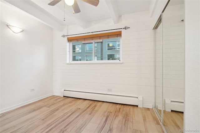 spare room featuring beam ceiling, a baseboard heating unit, a ceiling fan, and light wood-style flooring