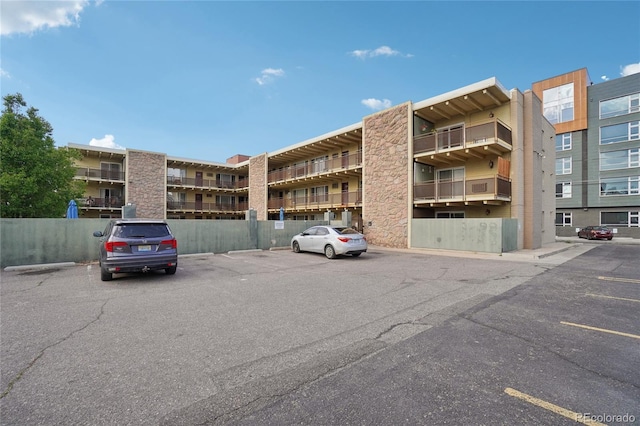 view of apartment building / complex featuring uncovered parking