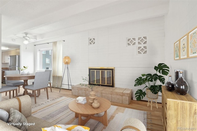 250 N Pearl St Unit 310, Denver, CO 80203 - living room featuring wood finished floors, a ceiling fan, and a tiled fireplace