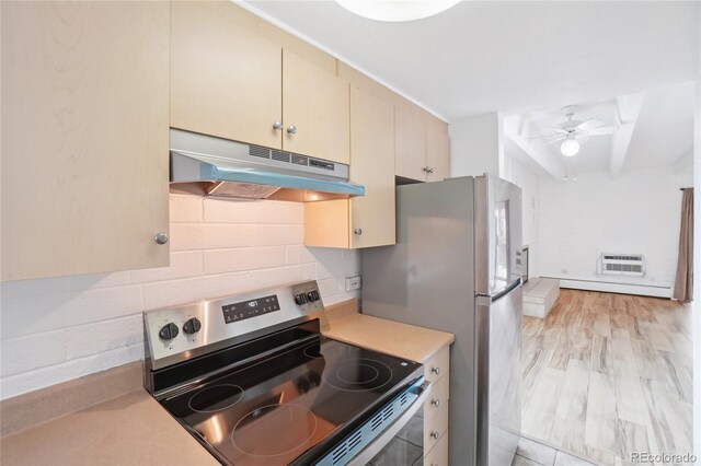 250 N Pearl St Unit 310, Denver, CO 80203 - kitchen featuring electric stove, under cabinet range hood, cream cabinets, light countertops, and a baseboard heating unit