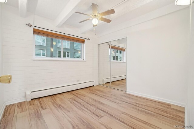 250 N Pearl St Unit 310, Denver, CO 80203 - spare room with a baseboard heating unit, beamed ceiling, wood finished floors, and a ceiling fan
