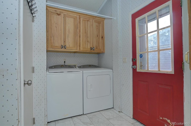 washroom featuring cabinets and separate washer and dryer