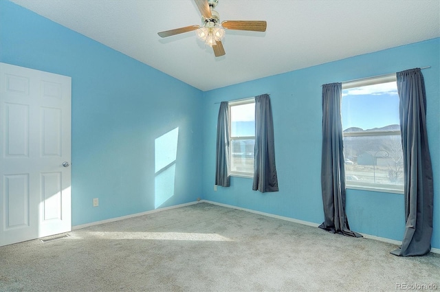 carpeted empty room with ceiling fan