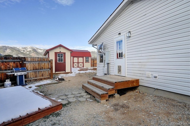 exterior space with a shed, a mountain view, and grilling area