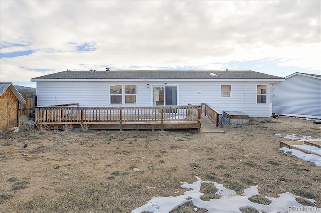 rear view of property featuring a deck