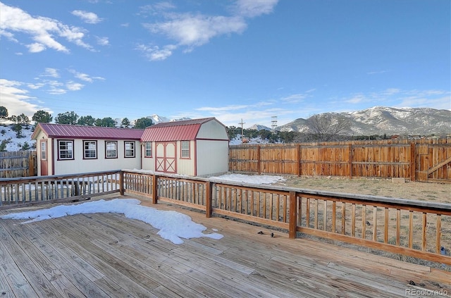 deck featuring a mountain view and a shed