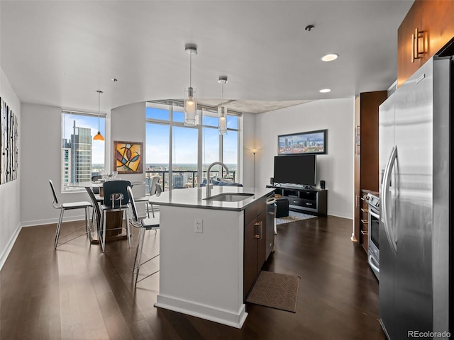 891 14th St Unit 3411, Denver, CO 80202 - kitchen with stainless steel appliances, a sink, a center island with sink, baseboards, and recessed lighting