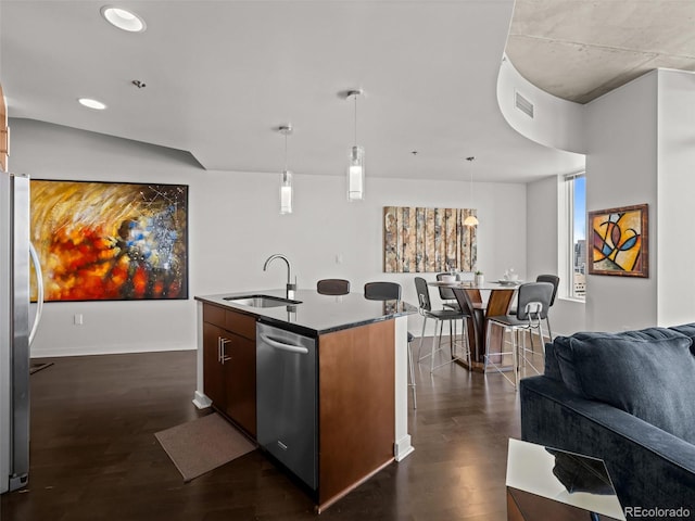 891 14th St Unit 3411, Denver, CO 80202 - kitchen featuring stainless steel appliances, a sink, open floor plan, dark wood-type flooring, and a center island with sink