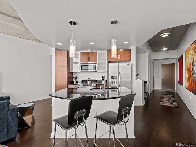 891 14th St Unit 3411, Denver, CO 80202 - kitchen featuring appliances with stainless steel finishes, dark countertops, dark wood-type flooring, recessed lighting, and baseboards