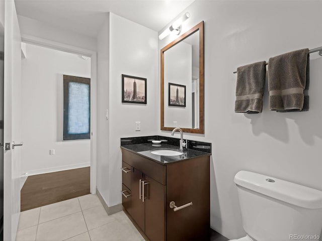 891 14th St Unit 3411, Denver, CO 80202 - bathroom with vanity, toilet, tile patterned flooring, and baseboards