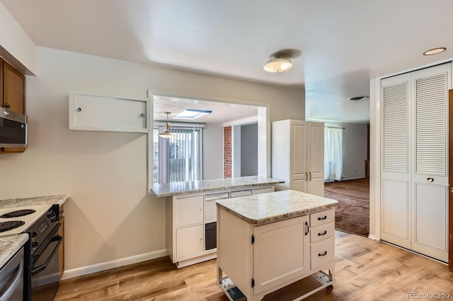 912 S Kingston St, Aurora, CO 80012 - kitchen featuring stainless steel microwave, black electric range oven, light wood-style floors, and baseboards