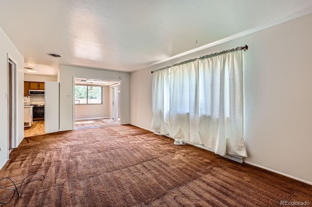 912 S Kingston St, Aurora, CO 80012 - unfurnished living room featuring carpet and baseboards