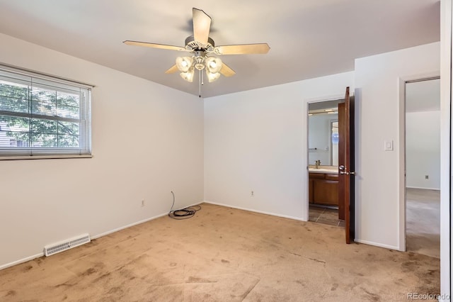 912 S Kingston St, Aurora, CO 80012 - unfurnished bedroom with light carpet, baseboards, connected bathroom, and ceiling fan