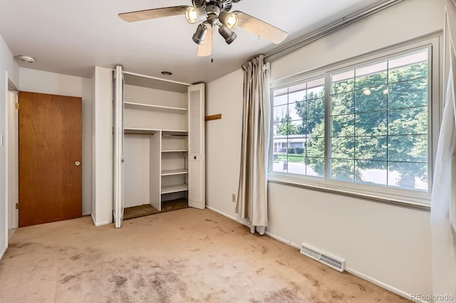 912 S Kingston St, Aurora, CO 80012 - unfurnished bedroom featuring multiple windows, carpet floors, a closet, and a ceiling fan