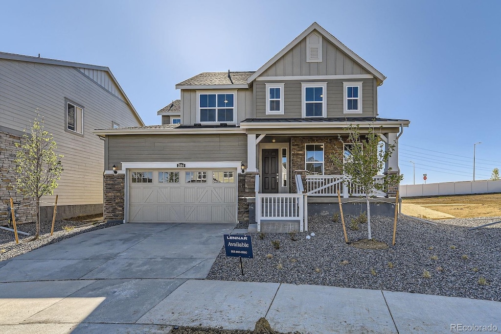 2184 S Gold Bug Ct, Aurora, CO 80018 - craftsman inspired home featuring board and batten siding, covered porch, concrete driveway, and stone siding