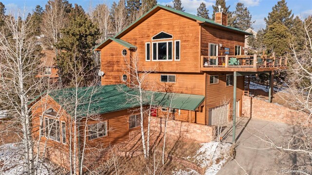 view of side of property with a deck and a garage