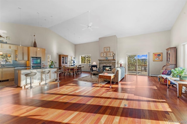 living room featuring high vaulted ceiling, ceiling fan, and hardwood / wood-style flooring