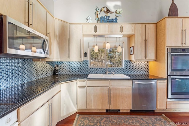 kitchen with sink, decorative backsplash, dark hardwood / wood-style flooring, appliances with stainless steel finishes, and light brown cabinets