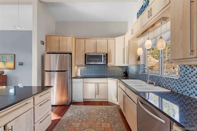 kitchen featuring stainless steel appliances, light brown cabinetry, and sink