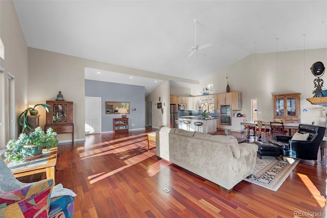 living room with ceiling fan, hardwood / wood-style floors, and high vaulted ceiling