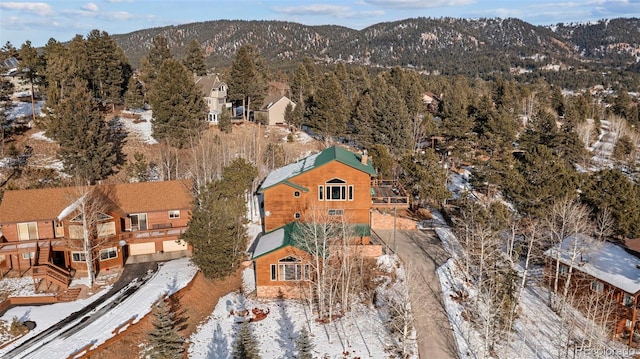 snowy aerial view with a mountain view