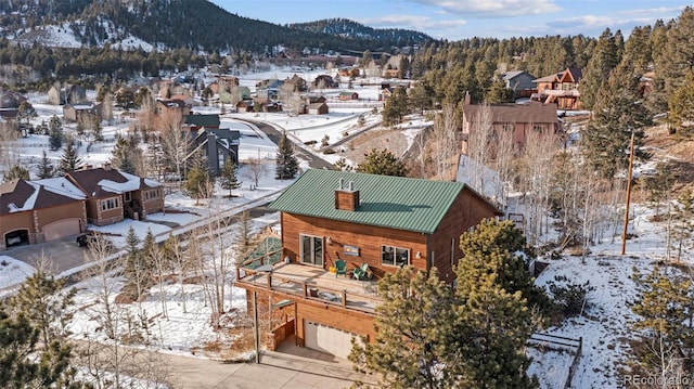 snowy aerial view with a mountain view