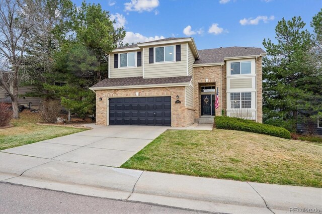 traditional-style home with roof with shingles, brick siding, driveway, a garage, and a front lawn