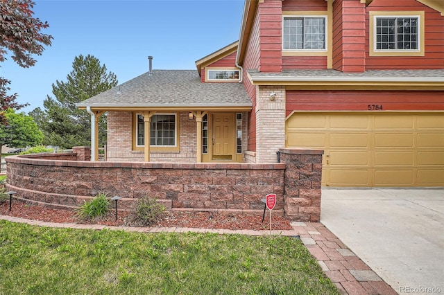 5784 W 81st Cir, Arvada, CO 80003 - view of front of property featuring brick siding, covered porch, an attached garage, roof with shingles, and concrete driveway